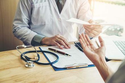 doctor handing lab results to patient